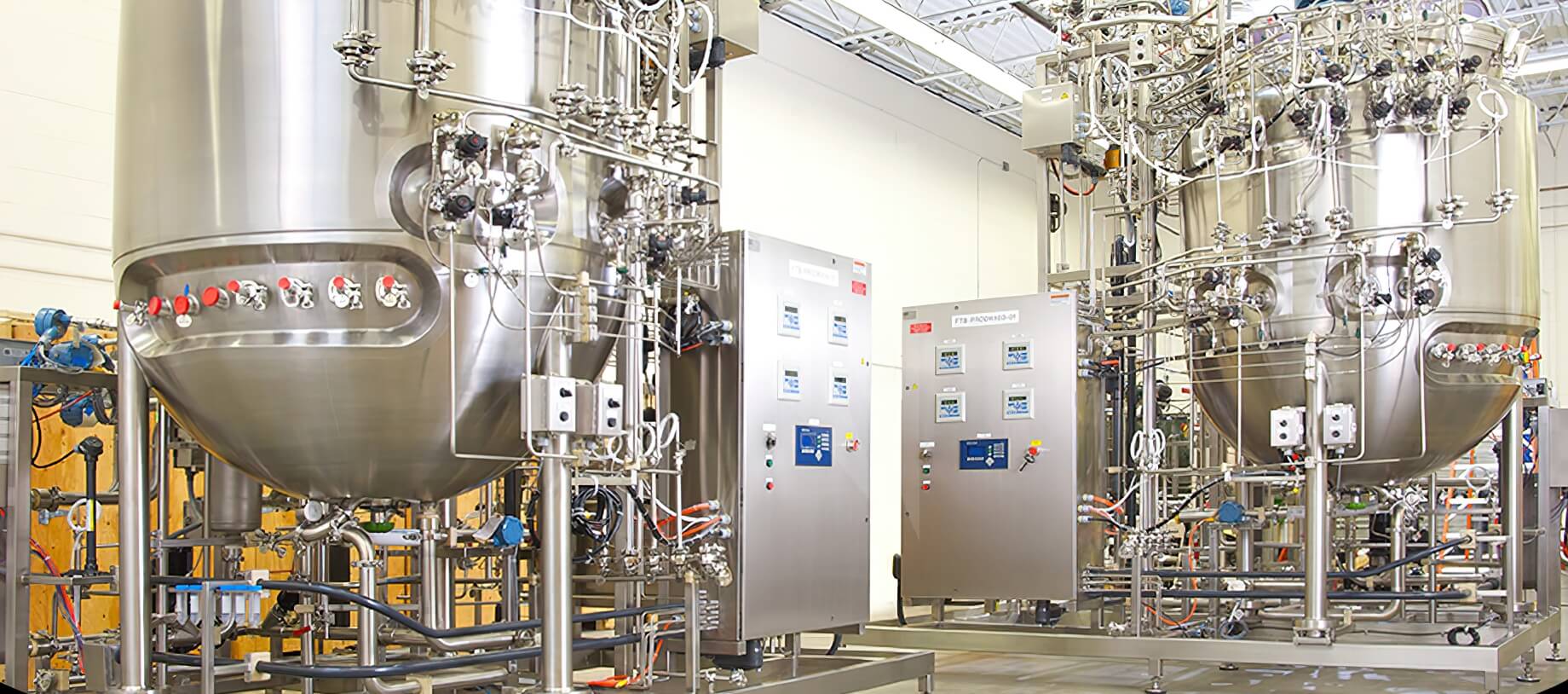 Picture close-up of lab technician working with a bioreactor. 